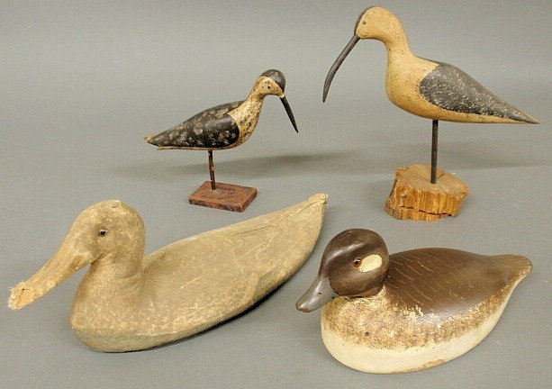Carved wood decoy of a hen bufflehead duck, 20th : Carved wood decoy of a hen bufflehead duck, 20th c., with original paint decoration 19.5" l. and a carved wood and paint decorated figure of a spotted sandpiper, 20th c., 7"h.x8"l.