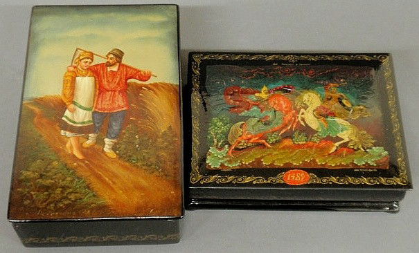 Two Russian lacquerware boxes, 20th c., one decor: Two Russian lacquerware boxes, 20th c., one decorated with a man and a woman and the other with two warriors on horseback, 2"h. each