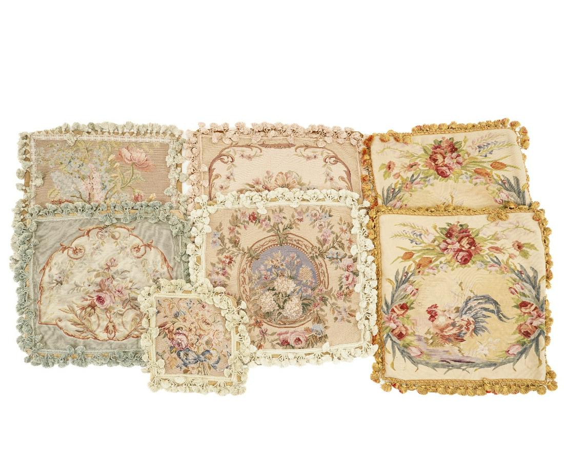 NEEDLEPOINT PILLOW COVERS: Six needlepoint pillow covers, approx. 22" x 22", with floral design, tasseled trim and velvet zippered backs, two by Pierre Deux, two by Chelsea Textiles; together with a smaller example, 11" x 11.5"