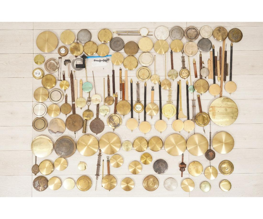 BRASS PENDULUM BOBS: Large collection of brass pendulum bobs, 20th c. Largest: 6.75"dia