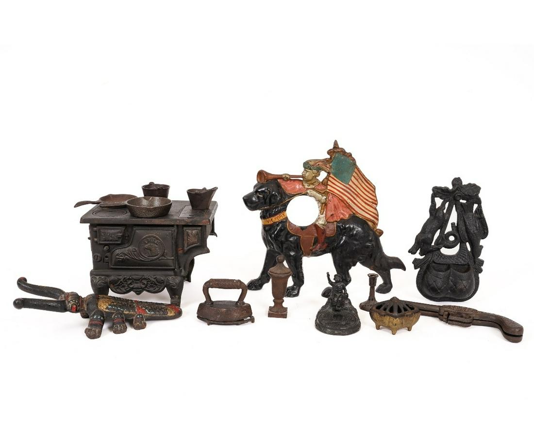CAST IRON ITEMS: Cast iron items to include a miniature cast iron Eagle Stove (missing one cover); gun shaped boot jack, a "Victory" clock face, match holder, etc. Stove: 6.25"h x 8.5"l x 5.25"d
