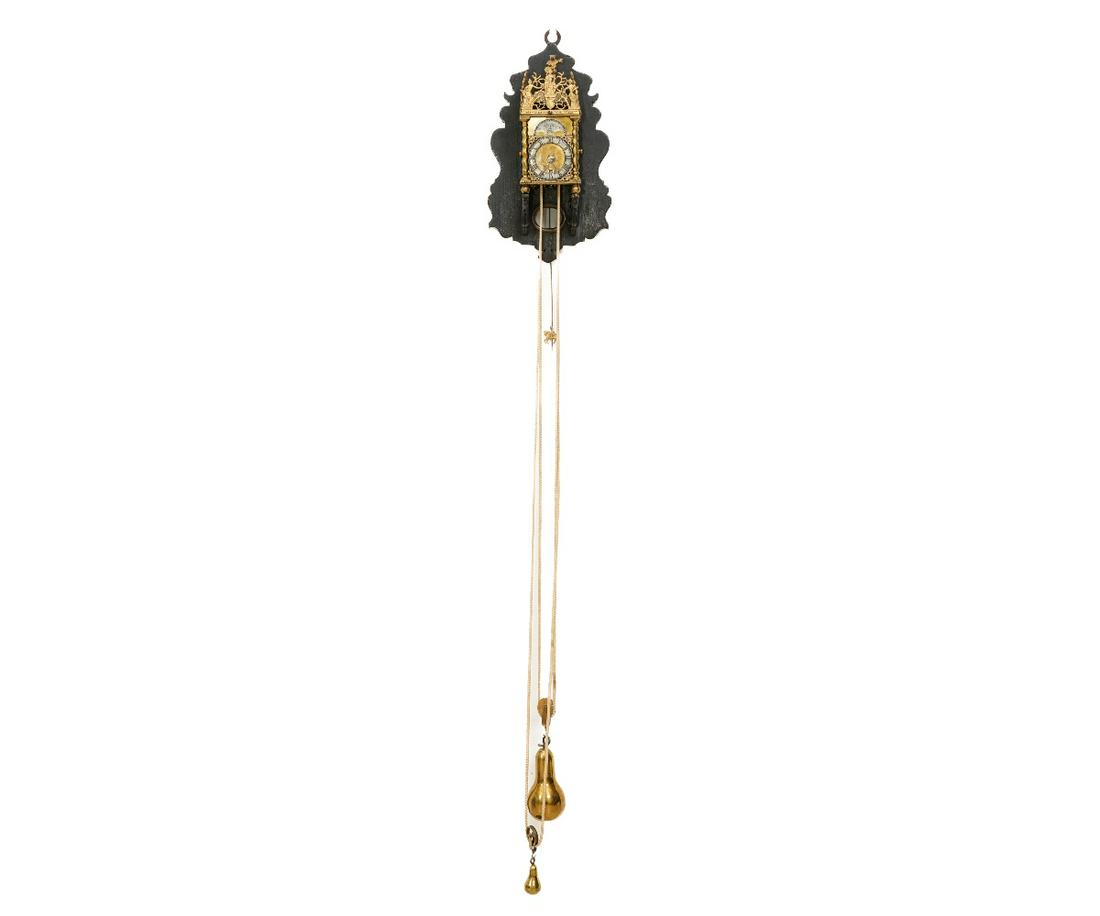MINIATURE LANTERN CLOCK: Miniature Dutch style brass lantern clock, mounted on a wooden bracket, with original bracket silk suspension, faux moon dial. 11.5"h x 6.5"w x 4.5"d oa