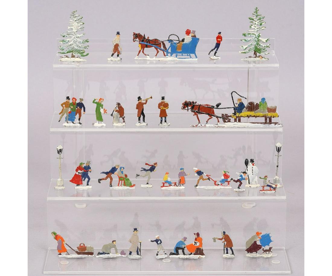 GERMAN FLAT LEAD CHRISTMAS FIGURES: 28 German flat lead Christmas figures by Hans Heinrichsen, marked H.H., to include sleighs, skaters, evergreens (2.5"h), etc.