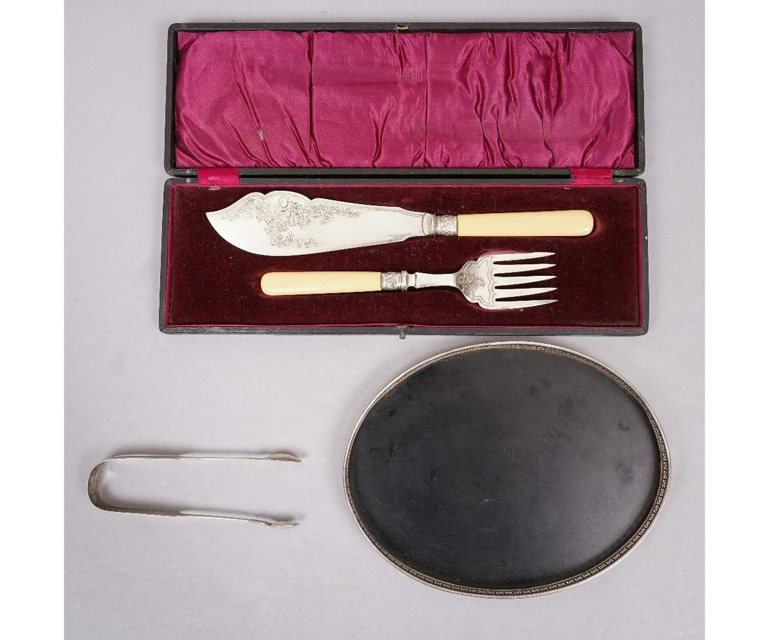 GEORGIAN SILVER SUGAR TONGS: Georgian silver sugar tongs by William Woodman 1831, 6"l; together with a sterling silver rimmed oval tray and a cased silver plate fish set.