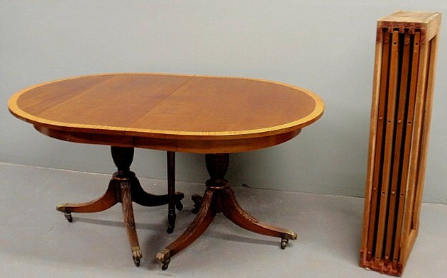 Duncan Phyfe style inlaid mahogany dining table w: Duncan Phyfe style inlaid mahogany dining table with cross-banded maple border, carved and reeded down-swept legs with brass paw feet and four extra leaves. 30”h.x44”w.x60”l., each leaf 15”l.