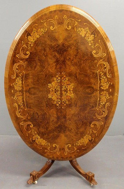 Oval Continental burlwood tilt-top table with ext: Oval Continental burlwood tilt-top table with extensive floral inlays, c.1870, and with finely carved legs and feet. 30”h.x55”l.x38”d.