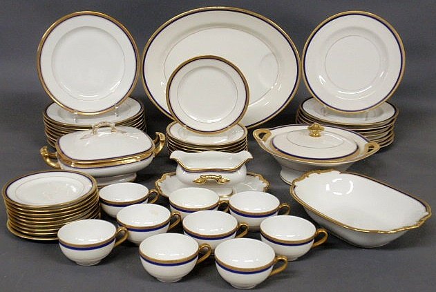 Partial Limoges dinner service with gilt and coba: Partial Limoges dinner service with gilt and cobalt blue borders to include: 17 dinner plates 9.75”, 8 small plates 7.5”, oval meat platter 15.75”l., 2 covered vegetable dishes, 1 open vegetable