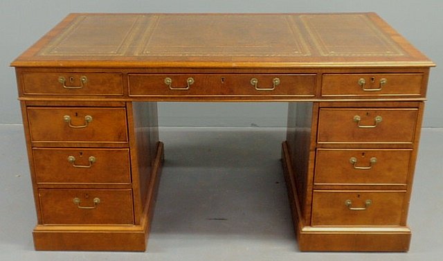 English burlwood partner’s desk, early 20th c., w: English burlwood partner’s desk, early 20th c., with a tooled leather top over three center drawers and two bases with doors on one side and drawers on the other side. 31”h., top 60”x35”