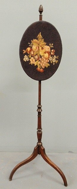 Delicate George III mahogany pole screen with an: Delicate George III mahogany pole screen with an oval floral needlepoint panel and spider legs. 50”h.