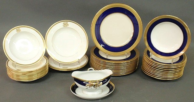 Twelve Lenox service plates with blue and gilt ba: Twelve Lenox service plates with blue and gilt band borders 10.5”, 12 similar Minton bowls 8.25”, a Portuguese porcelain gravy boat, 9 Minton gilt decorated bowls and 3 other bowls
