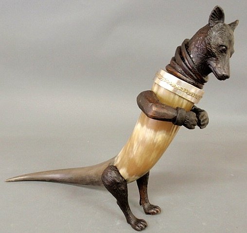 Black Forest fox, late 19th c., the body made fro: Black Forest fox, late 19th c., the body made from a horn, carved head and legs and silver and gold colored metal collar. 19.5”h.x21.5”l.