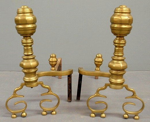Large pair of brass andirons, 19th c., with facet: Large pair of brass andirons, 19th c., with faceted tops and scrolled legs. 20”h.x10”w.x27”d.