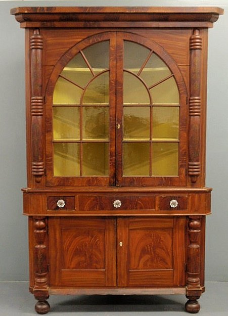 York County, Pennsylvania Rupp style two-piece co: York County, Pennsylvania Rupp style two-piece corner cupboard, early 19th c., with original paint decoration and having a bold molded cornice above two arched glass doors flanked by half-columns abov