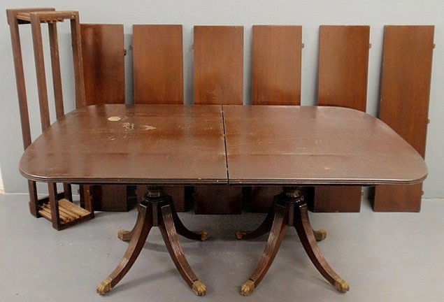 Mahogany two-part dining room table with a pedest: Mahogany two-part dining room table with a pedestal base and six extra leaves. 28”h.x46”w.x69.5”l., each leaf 12”l.