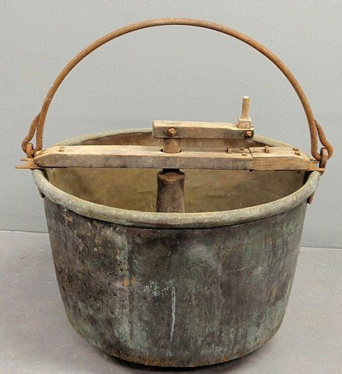 Copper apple butter kettle, 19th c., with a wrough: Copper apple butter kettle, 19th c., with a wrought iron handle and original stirrer. 19”h.x29”dia.