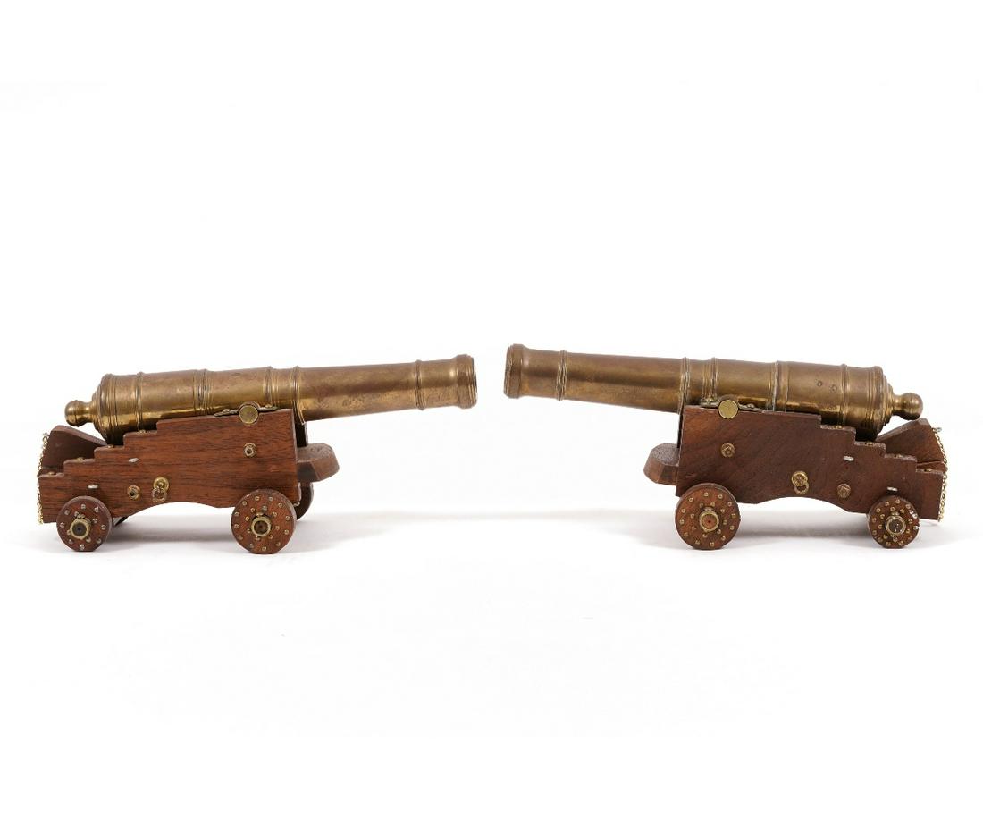 PAIR BRASS NAVAL CANNONS: Pair of brass naval cannons, 20th c., with walnut trucks. Both: 5"h x 12"l x 5"d