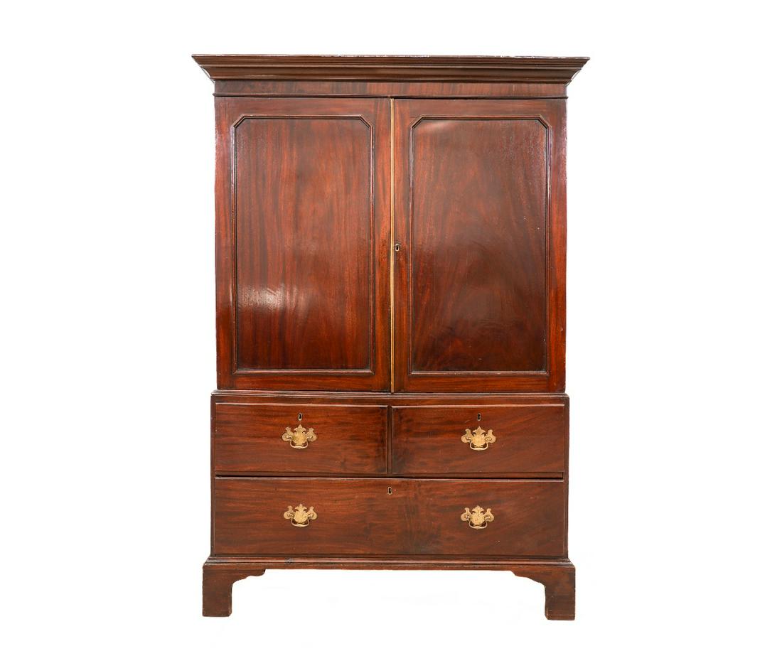 GEORGIAN LINEN PRESS: Georgian mahogany two-part linen press, circa 1780, with molded cornice, two blind doors, all over two drawers and straight bracket feet. 74"h x 51"w x 23.25"d