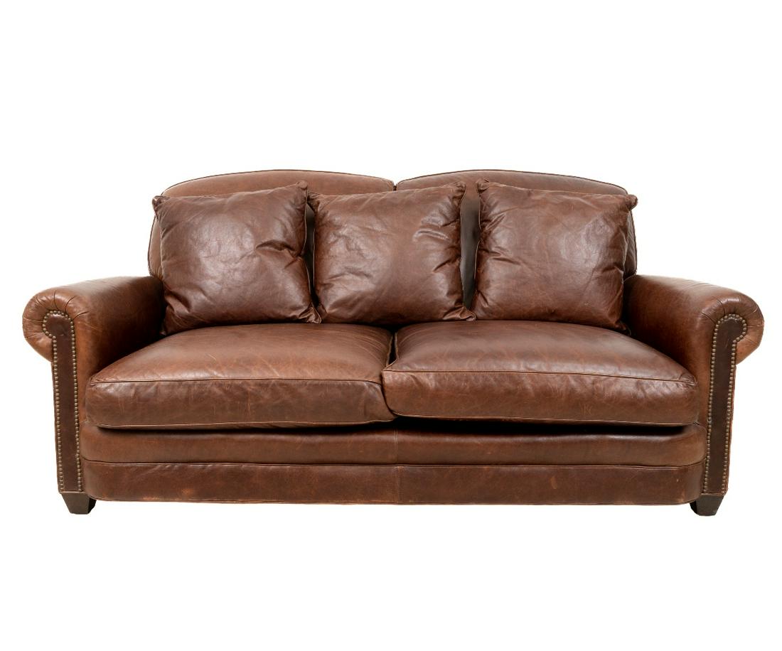 LEATHER SOFA: Leather sofa by Lee Industries with three pillows and brass studs. 35"h x 79"w x 28"d / 19" sh