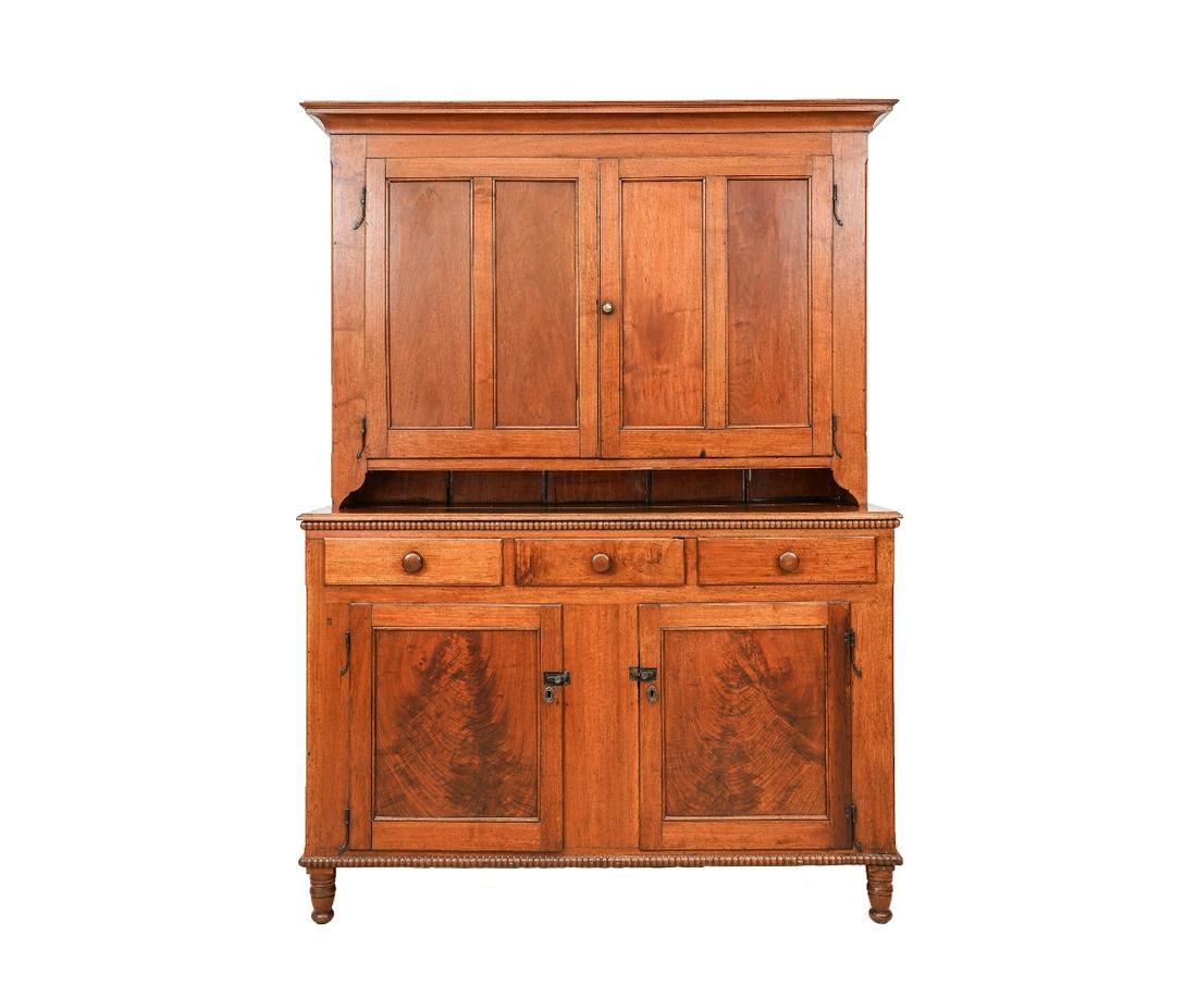 DUTCH CUPBOARD: Pennsylvania walnut Dutch cupboard circa 1830, with molded cornice with two blind doors with rat tail hinges, opening to shelved interior with spoon rack, all above a pie shelf, three drawers and matc