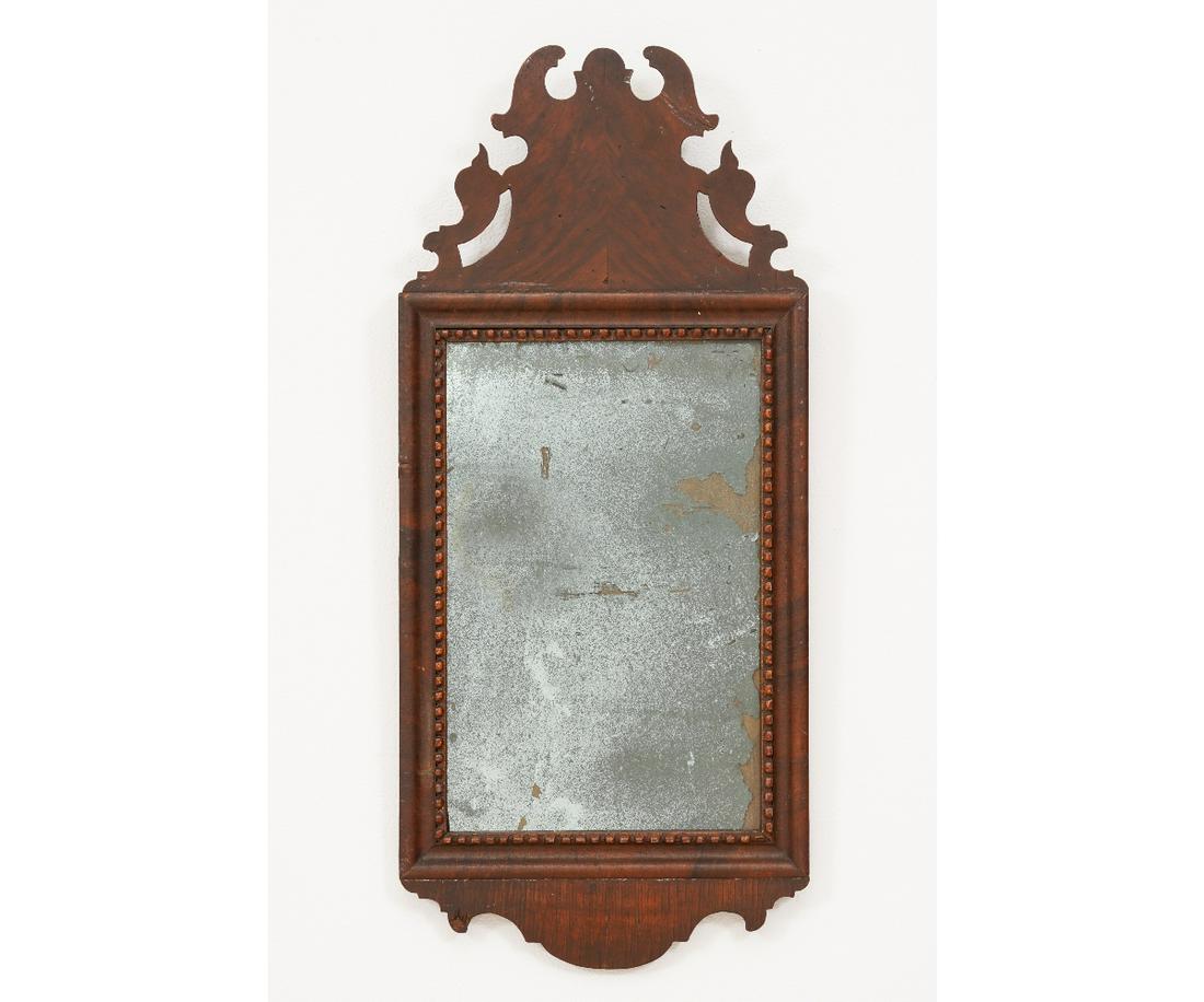 QUEEN ANNE STYLE COURTING MIRROR: Queen Anne style mahogany veneered courting mirror with carved crest, early 19th c. 26"h x 11.5"w