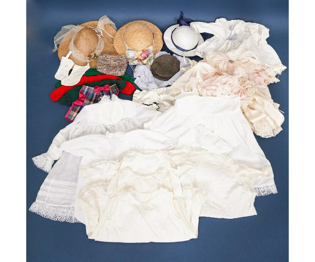 GROUPING OF DOLL CLOTHES: Grouping of doll clothes such as petticoats, hats, socks etc. including a peach and lace baby dress with matching bonnet by Charlotte Russet (good condition) and a larger white dress trimmed in lace b
