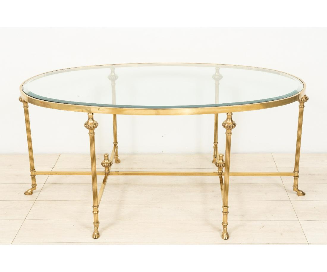 ITALIAN BEVELED GLASS COFFEE TABLE: Italian oval brass and beveled glass coffee table with clove feet. 22"h x 49.75"w x 32"d