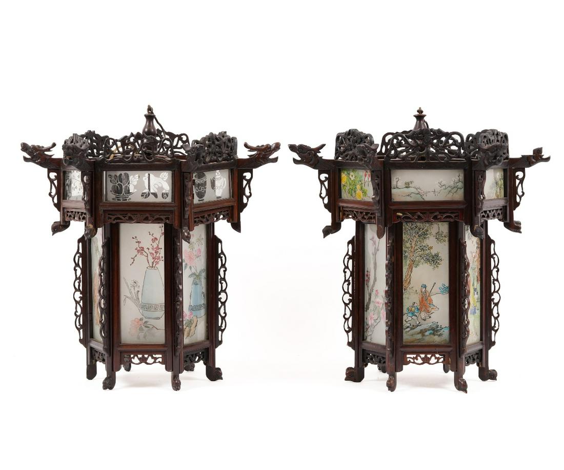 PAIR CHINESE PALACE LANTERNS: Pair of Chinese carved wood and decorated glass palace lanterns of hexagonal form, decorated with phoenix heads and electrified, 20th c. 21"h x 20"dia