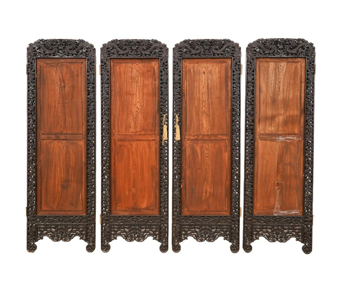 CHINESE IMPERIAL SCREEN: Chinese Imperial folding screen with carved dragons and bats, four sections, panel centers of a later date. 71.75"h x 22.75"w