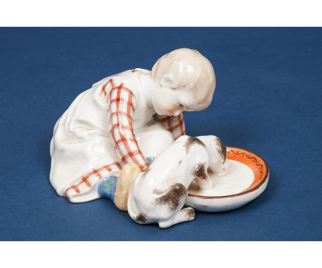 EARLY MEISSEN PORCELAIN FIGURE: Early Meissen porcelain group figure of a young boy with puppy, drinking water. 3.25"h x 6"l x 4.5"w