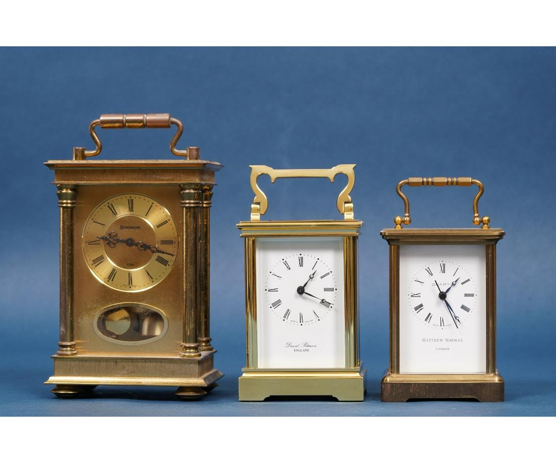 CARRIAGE CLOCKS etc.: Benchmark brass carriage clock; together with a David Peterson England example and a quartz clock, signed Matthew Norman. Tallest: 8"h x 4.25"w x 3.25"d