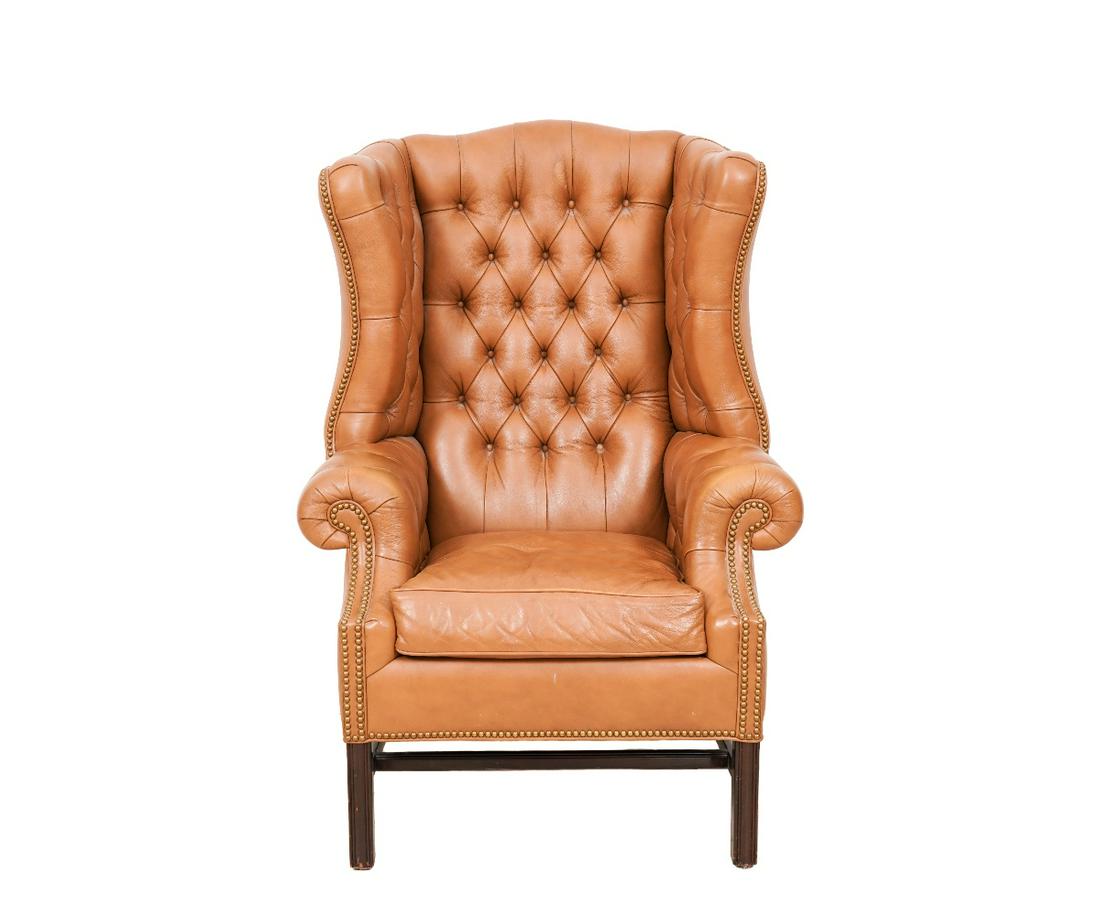HANCOCK & MOORE LEATHER WING CHAIR: Hancock & Moore Summerfield buttoned leather wing chair with brass studs and mahogany molded legs. 50"h x 35"w x 29"d / 19" sh