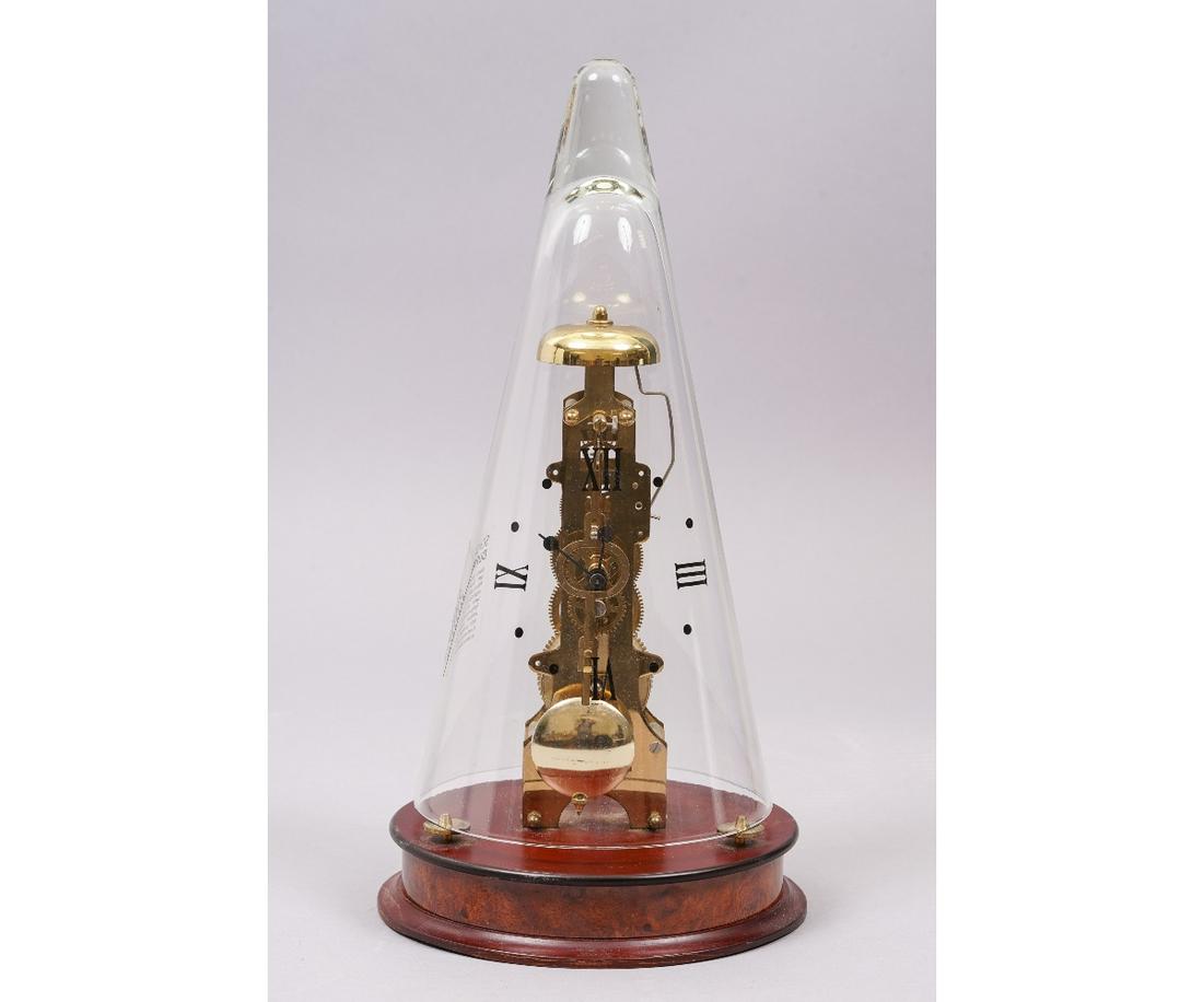 HERMLE LEYTON TABLE CLOCK: Glass domed Hermle Leyton modern windup table clock in a mahogany finish and 14-day bell strike movements, made in Germany. 14.5"h x 6"dia