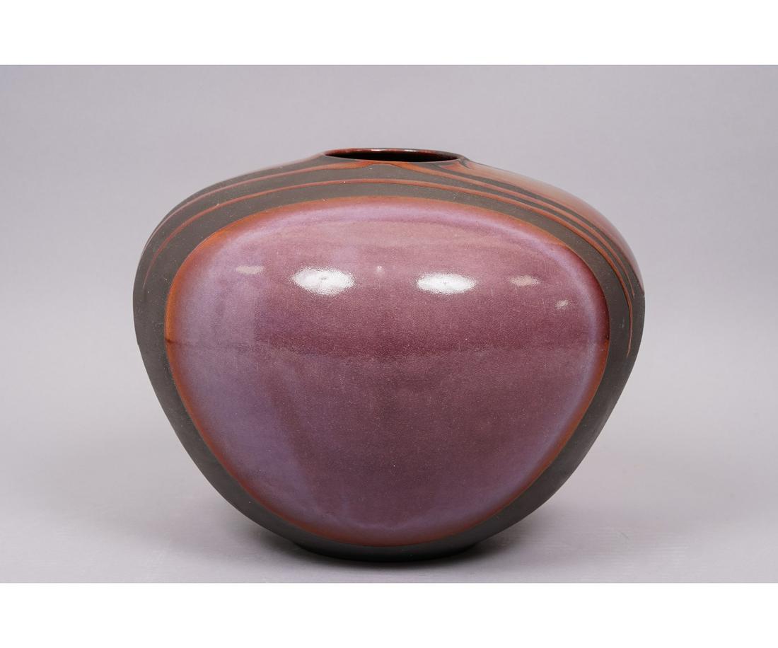 TONY EVANS RAKU POTTERY: Tony Evans large Raku pottery vessel, purple/red color. 10"h x 13"dia