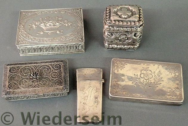 Four small silver boxes and a silver cased nail p: Four small silver boxes and a silver cased nail pick with an interior tortoiseshell cover, largest 3”l.