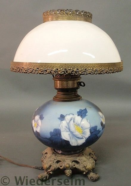 Gone-With-The-Wind lamp with a pot metal base and: Gone-With-The-Wind lamp with a pot metal base and blue floral decoration. 20.5”h.