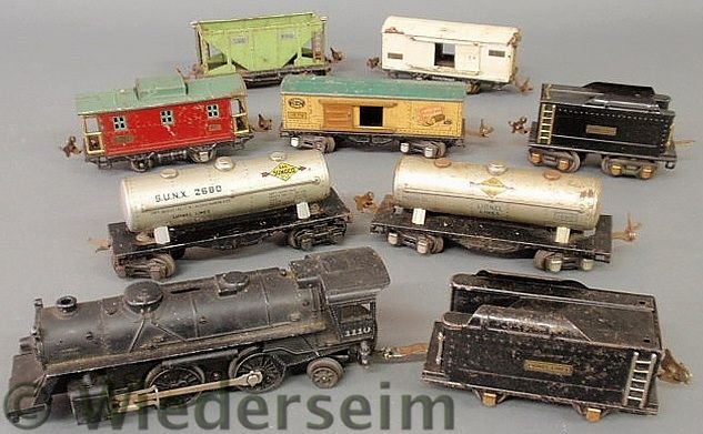 Lionel train set- locomotive #1110 8.5”l., 2 tend: Lionel train set- locomotive #1110 8.5”l., 2 tenders 5.75”l., 6 metal cars #653, #805, #1679, #807, # 1680 and another Sunoco tanker.