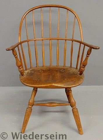 Sack-back Windsor armchair, early 19th c., with b: Sack-back Windsor armchair, early 19th c., with baluster turned arm supports, shaped seat and turned legs. 35.5”h.x25”w.x15”d., seat 17”h.
