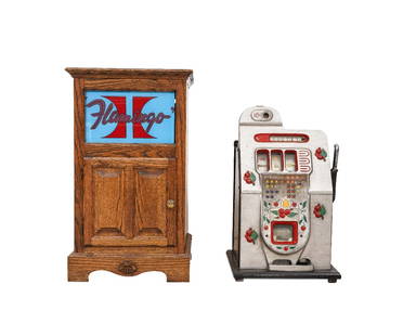 VINTAGE SLOT MACHINE: Vintage Mills Novelty Co. 10 cent slot machine, circa 1950, with key; together with a small oak cabinet with lighted glass panel, 31"h x 18"w x 17.5"d. Slot machine: 28"h x 16"w x 10"d