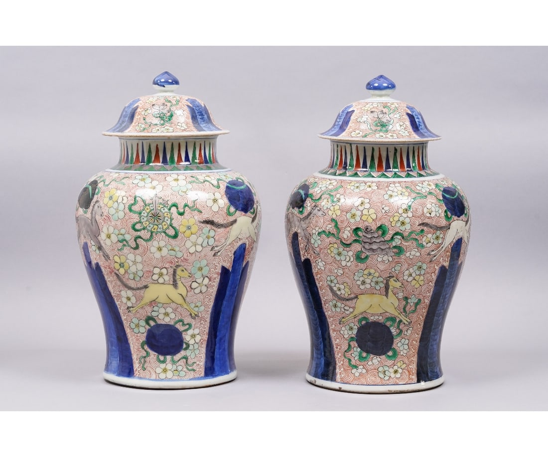 PAIR CHINESE PORCELAIN TEMPLE URNS: Large pair of colorful Chinese porcelain covered temple urns each decorated with horses and flowers all on a red reserve. 18"h x 10"dia overall