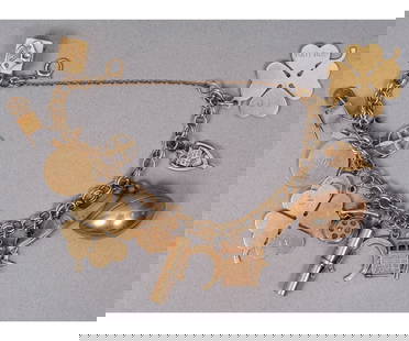 14K GOLD CHARM BRACELET: 14k yellow gold charm bracelet with thirteen 14k gold charms and three 10k gold charms. Approximately 9.5"l (including the safety chain) / 33 dwt