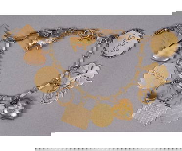14K GOLD CHARM BRACELET: 14k gold charm bracelet with eleven, mostly 14k, gold charms with safety chain. Bracelet: 7"l / 21 dwt