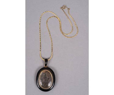 VICTORIAN ONYX MOURNING LOCKET: Victorian onyx mourning locket circa 1880 with braided hair, monogrammed with chip diamonds all on a 14k gold chain. 1.75"h x 1.25"w / Chain: 18"l