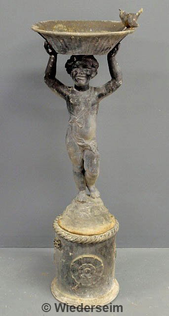 Two-part lead garden fountain of a boy holding a r: Two-part lead garden fountain of a boy holding a round basket above his head, 20th c. As found. 43.5"h.