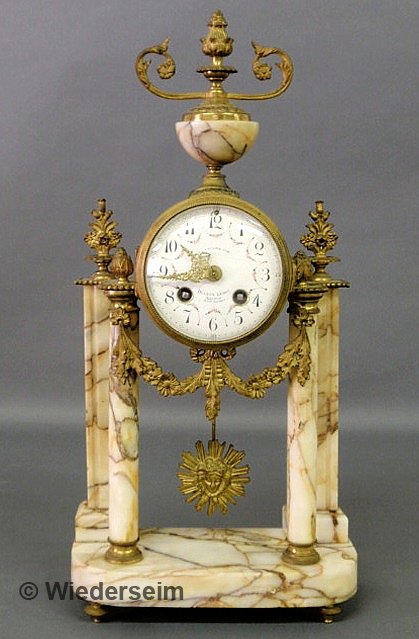 Ornate French marble column clock signed "A LA Ger: Ornate French marble column clock signed "A LA Gerbe d'or, Duceux Leroy, Amiens Place Gambett", late 19th c./early 20th c., with brass ormolu mounts. 18"h.x8.5"w.