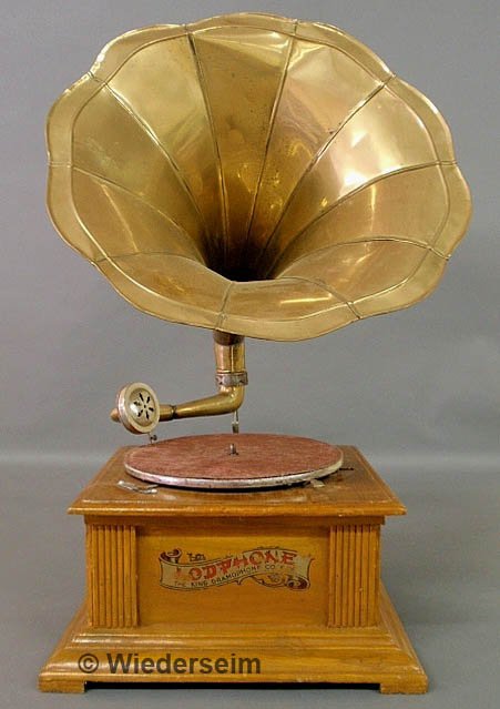 Mahogany cased phonograph with a brass morning glo: Mahogany cased phonograph with a brass morning glory horn, the case labeled "Lodphone, The King Gramophone Co.". 27"h., case 14.5"x14.5"