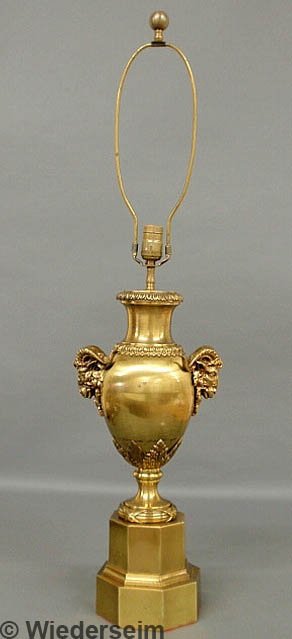 Urn form brass table lamp with ram's head mask han: Urn form brass table lamp with ram's head mask handles and octagonal base. 25"h. to top of socket, 38.5"h. overall