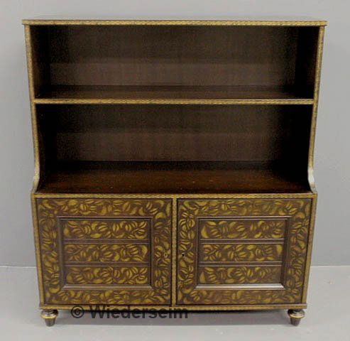 Kittinger open bookcase with two lower doors and b: Kittinger open bookcase with two lower doors and black and gilt decoration. 46"h.x41"w.x16"d.
