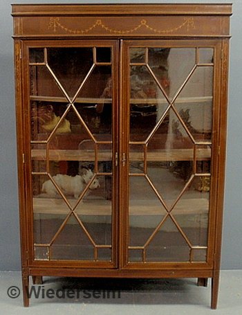 Hepplewhite style inlaid mahogany glass front cabi: Hepplewhite style inlaid mahogany glass front cabinet with a shelved interior. 72.5"h.x49"w.x15.5"d.