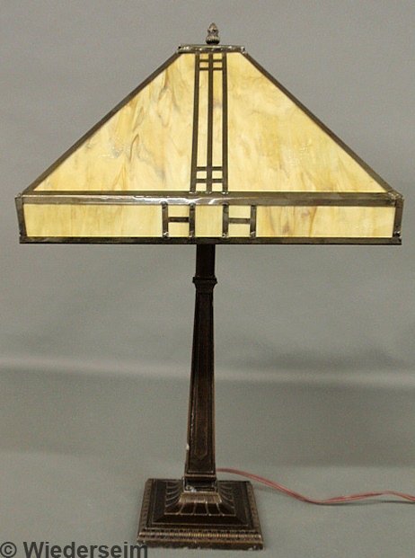 Contemporary Arts & Crafts style metal table lamp: Contemporary Arts & Crafts style metal table lamp with a slag glass shade. 26"h.