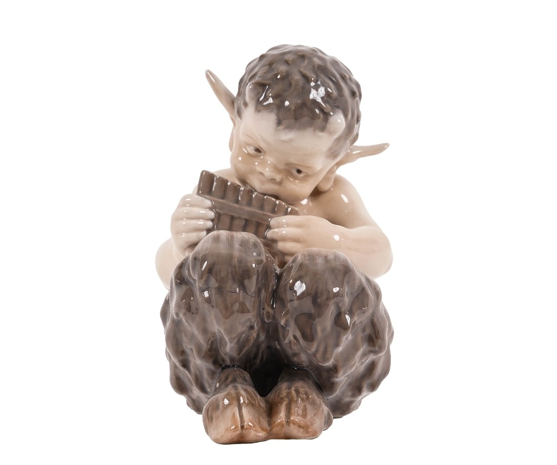 ROYAL COPENHAGEN: Royal Copenhagen figure of seated Pan playing a flute. 6"h x 3.5"w x 5"d